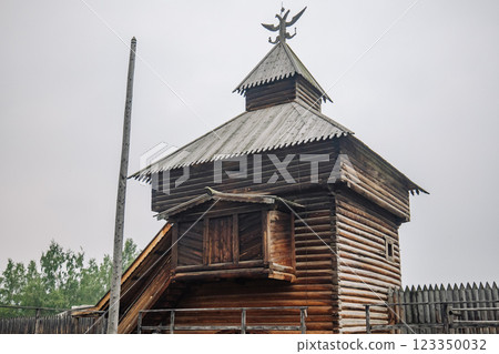 Majestic wooden tower with a double headed eagle, showcasing traditional russian architecture within a historic fortress Majestic wooden tower with a double headed eagle, showcasing traditional russian architecture within a historic fortress 123350032