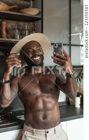 cheerful black african american man making selfie photo for social media, smiling person takes joyful picture in cozy kitchen, radiating friendliness and comfort in modern home setting 123350383