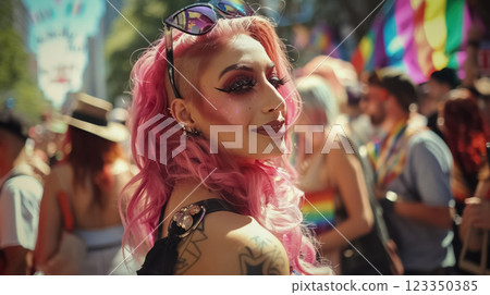 young queer woman with pink vibrant hair celebrating pride parade, gay or lesbian person with rainbow colors signs and vivid makeup 123350385