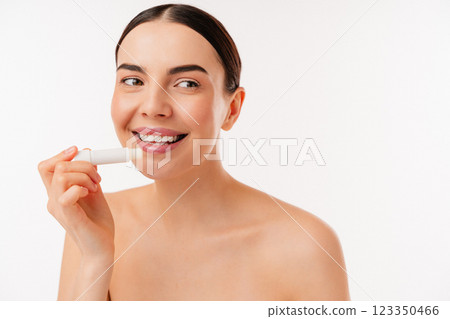 Smiling Person Applying Lip Balm With Natural and Fresh Expression Smiling Person Applying Lip Balm With Natural and Fresh Expression 123350466