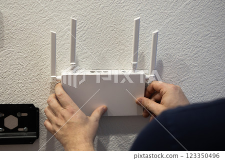 For optimal connectivity, installing a wireless router on the wall can enhance signal strength 123350496