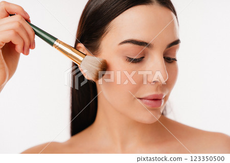 Applying Natural Makeup with a Soft Brush on Smooth Skin Applying Natural Makeup with a Soft Brush on Smooth Skin 123350500