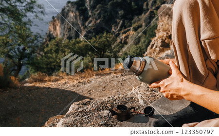 Exploring the Beauty of Nature with a Thermos Enjoying a Peaceful Moment Outdoors with Friends Exploring the Beauty of Nature with a Thermos Enjoying a Peaceful Moment Outdoors with Friends 123350797