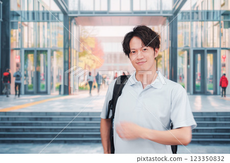 Male students walking on university campus 123350832