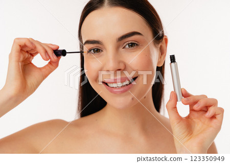 Smiling Person Applying Mascara During Makeup Routine 123350949