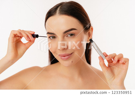 Young Person Applying Mascara in a Beauty Routine Close-Up 123350951