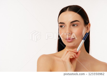 Natural Beauty Holding Mascara for Promotional Cosmetics Shoot on Isolated Background 123350962