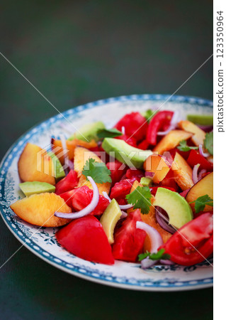 Fresh spring salad witn avocado, tomato, peach, red onion and herbs Fresh spring salad witn avocado, tomato, peach, red onion and herbs 123350964