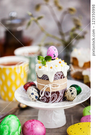 Sweet Easter bread, panettone or kulich and colorful painted eggs, Holiday spring concept Sweet Easter bread, panettone or kulich and colorful painted eggs, Holiday spring concept 123350998