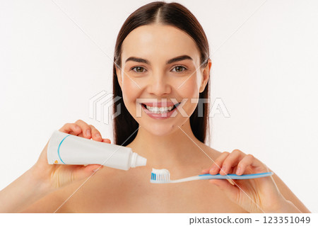 Smiling Person Brushing Teeth With Toothpaste for Oral Hygiene and Fresh Smile Smiling Person Brushing Teeth With Toothpaste for Oral Hygiene and Fresh Smile 123351049