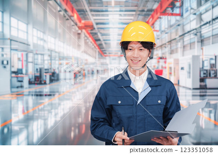 Young male staff working in a cutting-edge factory Young male staff working in a cutting-edge factory 123351058