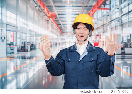 Young male staff working in a cutting-edge factory 123351062