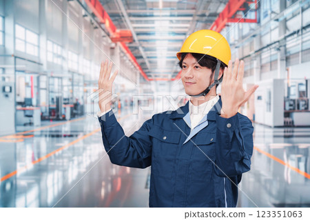Young male staff working in a cutting-edge factory Young male staff working in a cutting-edge factory 123351063
