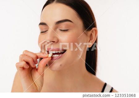 Woman Enjoying a Healthy Snack in a Bright Setting Woman Enjoying a Healthy Snack in a Bright Setting 123351068