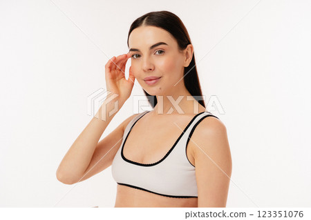 Elegant Individual in Fashionable Apparel Posing Against a Minimalist Background Elegant Individual in Fashionable Apparel Posing Against a Minimalist Background 123351076