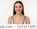 Smiling Individual Portrait with Positive Expression in a Neutral Setting 123351085