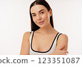 Confident Woman Smiling in Minimalist Studio Against a White Background 123351087