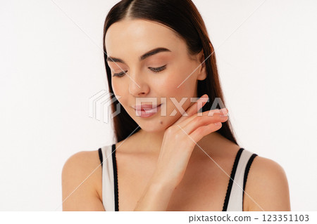 Young Person With Smooth Skin Showing a Natural Glow in Casual Attire Young Person With Smooth Skin Showing a Natural Glow in Casual Attire 123351103