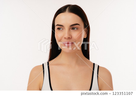 Portrait of a Confident Individual Smiling in Minimalistic Studio Lighting 123351107