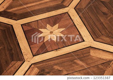 Intricate Star Pattern on Vintage Wooden Parquet Flooring Intricate Star Pattern on Vintage Wooden Parquet Flooring 123351387