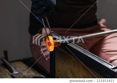 Molding red molten glass into a flower Molding red molten glass into a flower 123351413