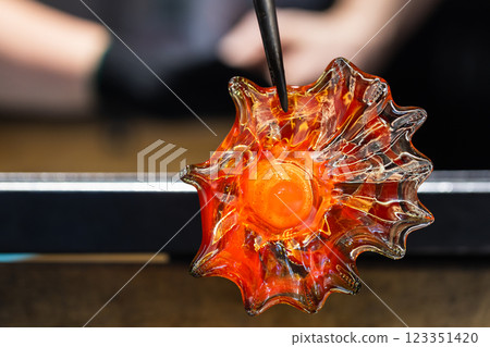 Glowing red molten glass in shape of a flower Glowing red molten glass in shape of a flower 123351420