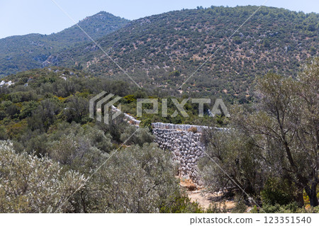 Summer landscape with the Ancient Roman Delikkemer aqueduct bridge Summer landscape with the Ancient Roman Delikkemer aqueduct bridge 123351540