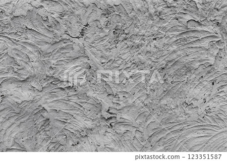 Grungy gray concrete wall with chaotic relief texture, front view 123351587