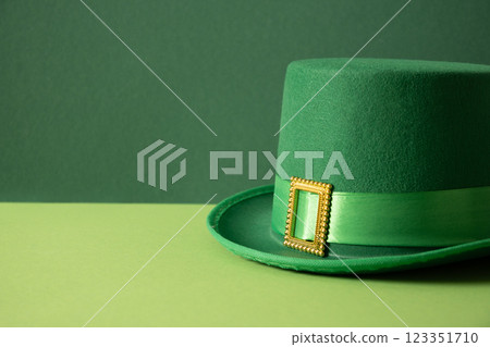 St Patricks day and March 17 concept with green parade Leprechaun Hat with belt and buckle on green background. Close up. Copy space. 123351710