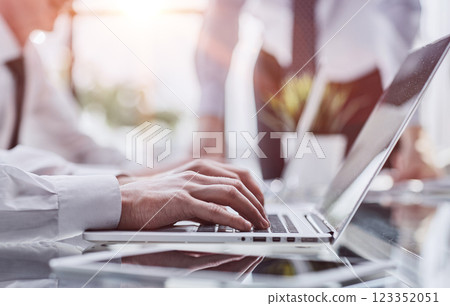 Business man sitting at table surfing the internet, online working at office, telecommuting concept 123352051