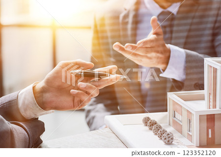 two successful people are discussing a house construction project. layout on the table 123352120