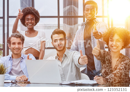 Employees working at computer together, discussing content 123352131