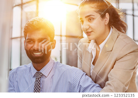 Working together on project. Two young business colleagues working on computer 123352135