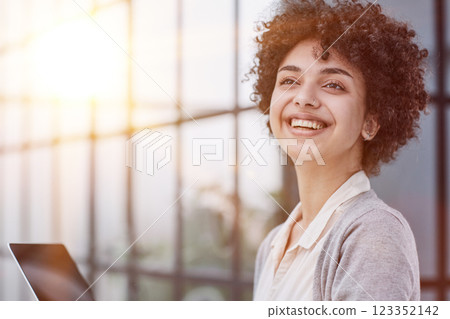 Young Stylish Female with Curly Hair Using Laptop Young Stylish Female with Curly Hair Using Laptop 123352142