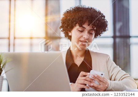 Portrait of Young Successful Caucasian Businesswoman Sitting at Desk Working on Laptop Portrait of Young Successful Caucasian Businesswoman Sitting at Desk Working on Laptop 123352144