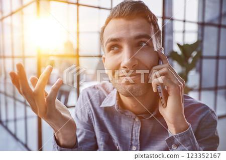 Businessman shopping over the phone in an office Businessman shopping over the phone in an office 123352167