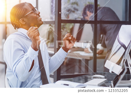 happy man working in the office. raised his hands joyfully 123352205