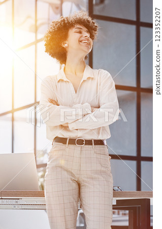 girl in the office smiles expresses success and leadership is thinking about success 123352207