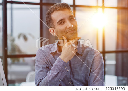 Serious thoughtful millennial business man looking away Serious thoughtful millennial business man looking away 123352293