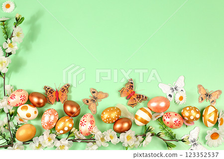 Abstract spring easter composition with golden painted eggs, feathers, butterflies, blossom branches and flowers. Happy easter concept. Screen banner with space for greeting text, 123352537