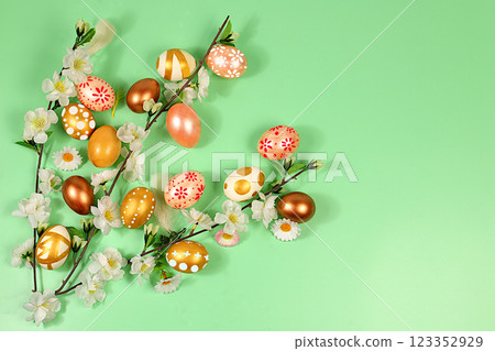 Abstract spring easter composition with blue painted eggs, feathers, butterflies, flowering branches and flowers. Happy easter concept. Screen banner 123352929