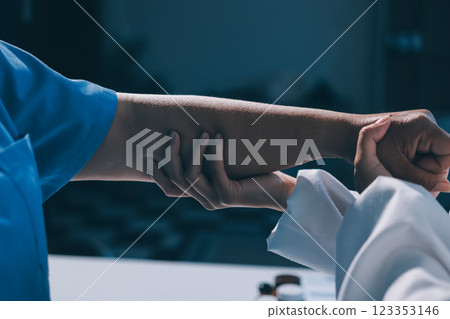Orthopedist examining patient in hospital Orthopedist examining patient in hospital 123353146
