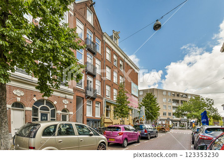 A picturesque urban street showcasing historic buildings, lush greenery, and colorful vehicles under a bright sky, inviting exploration and leisure. A picturesque urban street showcasing historic buildings, lush greenery, and colorful vehicles under a bright sky, inviting exploration and leisure. 123353230