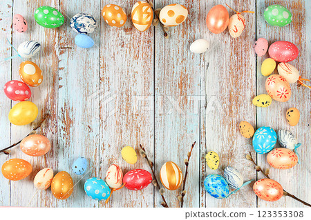 Composition with decorated Easter eggs and willow branches. Happy Easter concept, banner or advertisement for screen or store, template for design, spring card, selective focus Composition with decorated Easter eggs and willow branches. Happy Easter concept, banner or advertisement for screen or store, template for design, spring card, selective focus 123353308