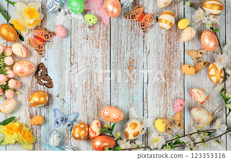 Composition with decorated Easter eggs, butterflies and apple tree branches. Happy Easter concept, banner or advertisement for screen or store, template for design, spring card, selective focus Composition with decorated Easter eggs, butterflies and apple tree branches. Happy Easter concept, banner or advertisement for screen or store, template for design, spring card, selective focus 123353316