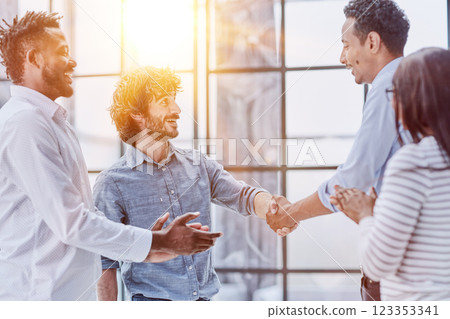 Successful Business Collaboration: Executives Greet with Handshake in Office 123353341