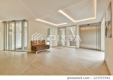 A sleek and modern interior lobby featuring stylish lighting, an elevator, and a minimalistic design. Perfect for contemporary architectural showcases. 123353342