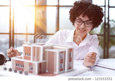 female architect designer examines house layout female architect designer examines house layout 123353352