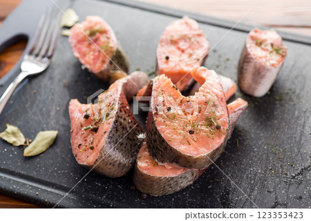 Salmon steaks with herbs and black pepper Salmon steaks with herbs and black pepper 123353423