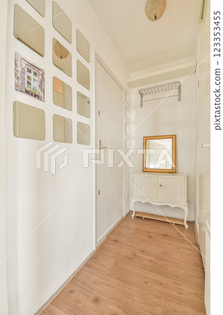 A bright and airy entrance hall featuring stylish mirrors, a decorative mirror, and wooden flooring, creating a welcoming atmosphere. A bright and airy entrance hall featuring stylish mirrors, a decorative mirror, and wooden flooring, creating a welcoming atmosphere. 123353455